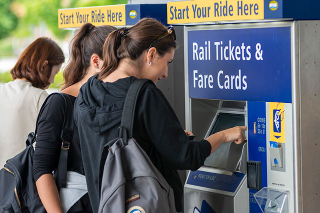 students buying light rail tickets